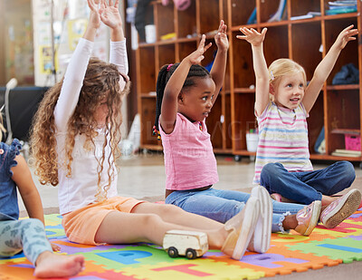 Buy stock photo Education, raise hands and children in kindergarten in a classroom for education or knowledge. Daycare, happy and young kid students with a question gesture for learning in lesson together at nursery