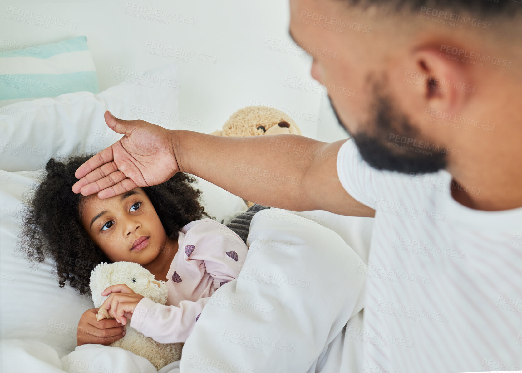 Buy stock photo Shot of a young father looking after his sick daughter at home
