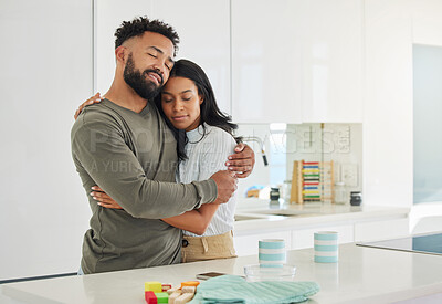 Buy stock photo Shot of a young couple hugging at home