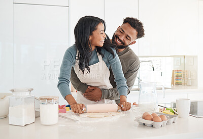 Buy stock photo Cropped shot of an affectionate young couple baking together in the kitchen at home