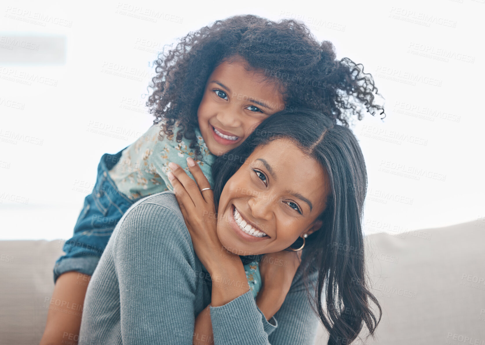 Buy stock photo Shot of a mother and her little daughter relaxing together at home