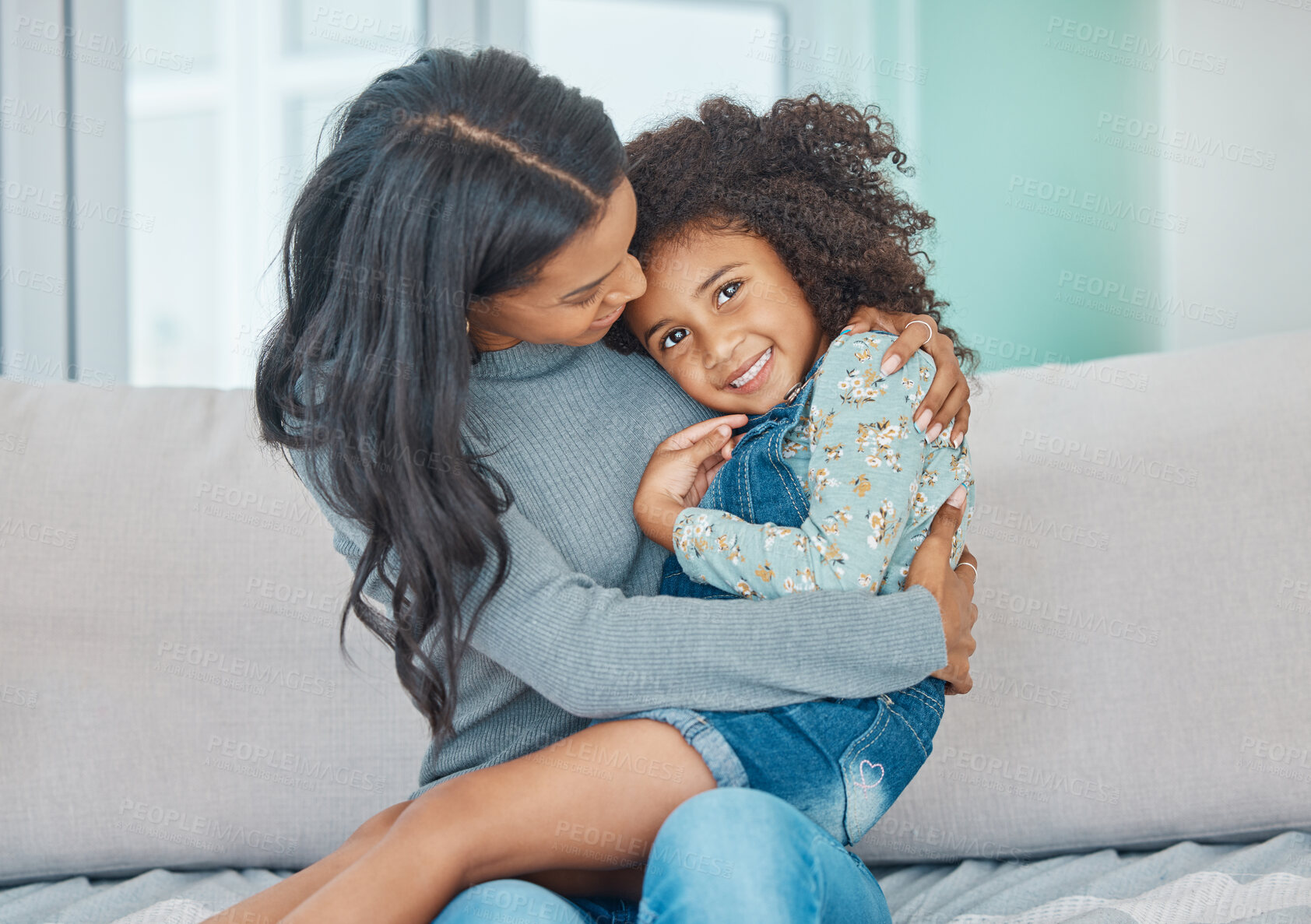 Buy stock photo Shot of a mother and her little daughter relaxing together at home