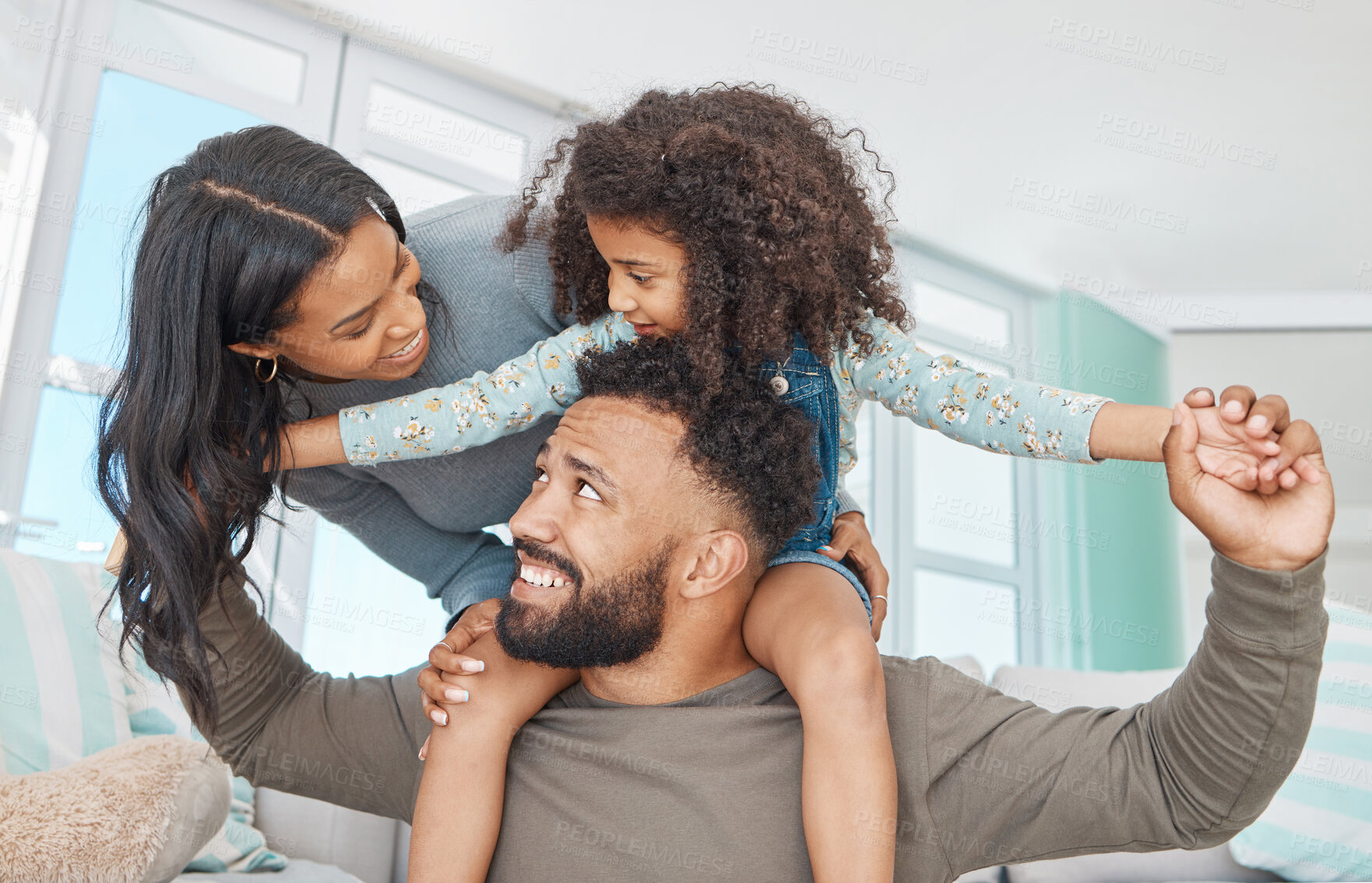 Buy stock photo Home, mother and father with child on shoulder, playful and bonding together as family on weekend. Sofa, mom or dad with girl with carrying for childhood game, connection or relationship with parents