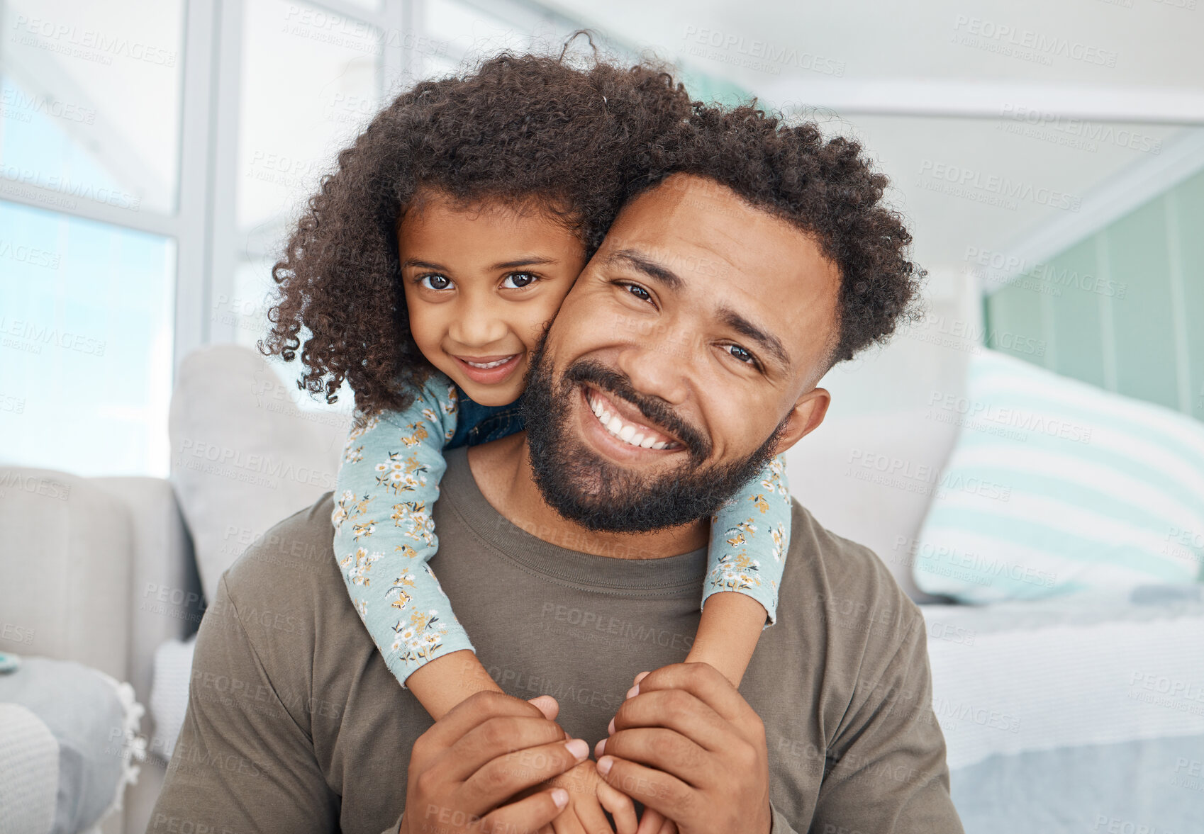 Buy stock photo Shot of a father and his little daughter relaxing together at home