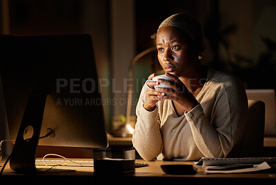 Buy stock photo Shot of a young businesswoman drinking coffee while working on a computer in an office at night