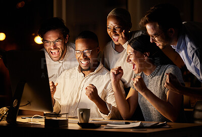 Buy stock photo Shot of a group of businesspeople cheering while working together on a computer in an office at night