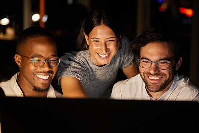 Buy stock photo Shot of a group of businesspeople working together on a computer in an office at night