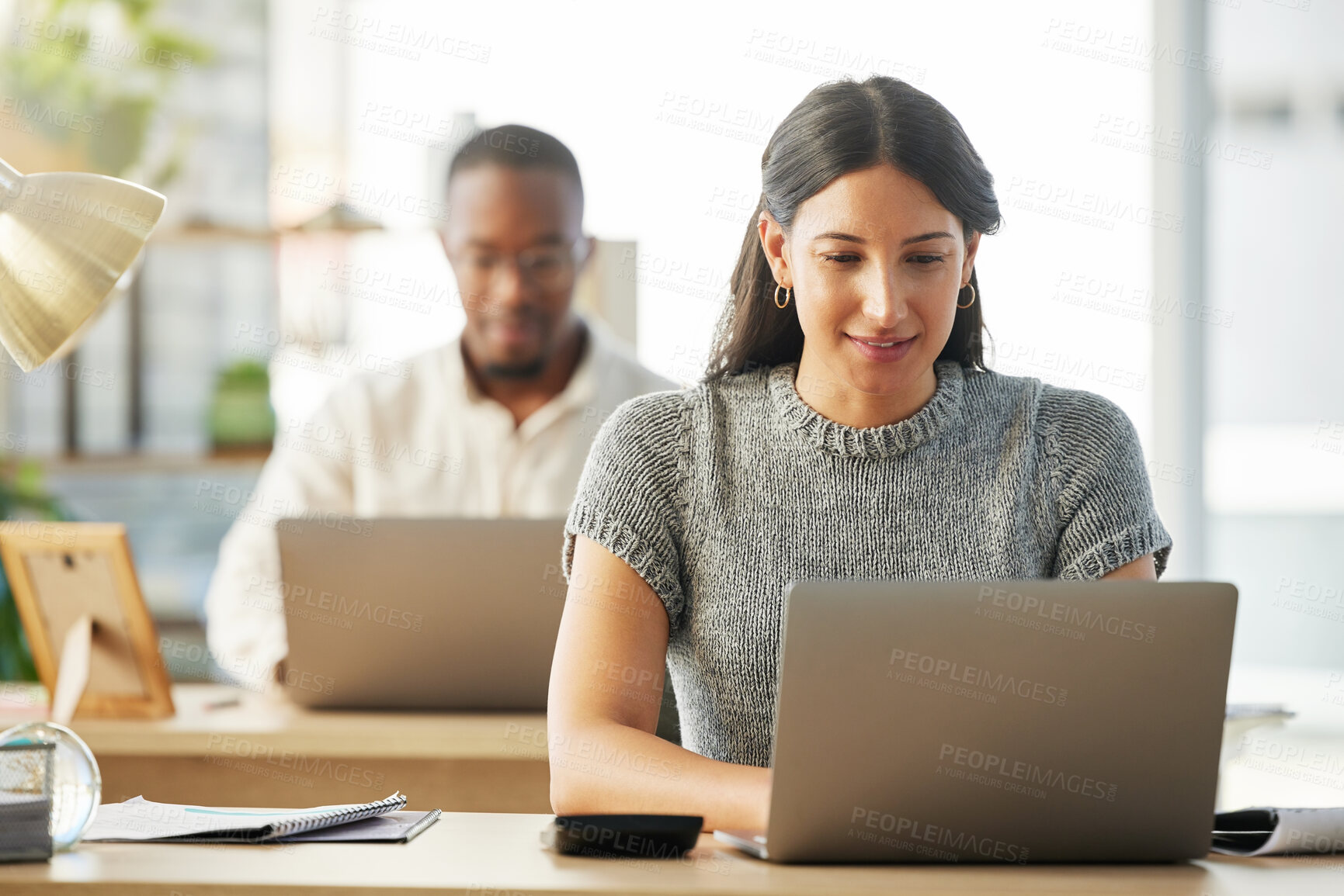 Buy stock photo Shot of a group of young businesspeople working together in their office