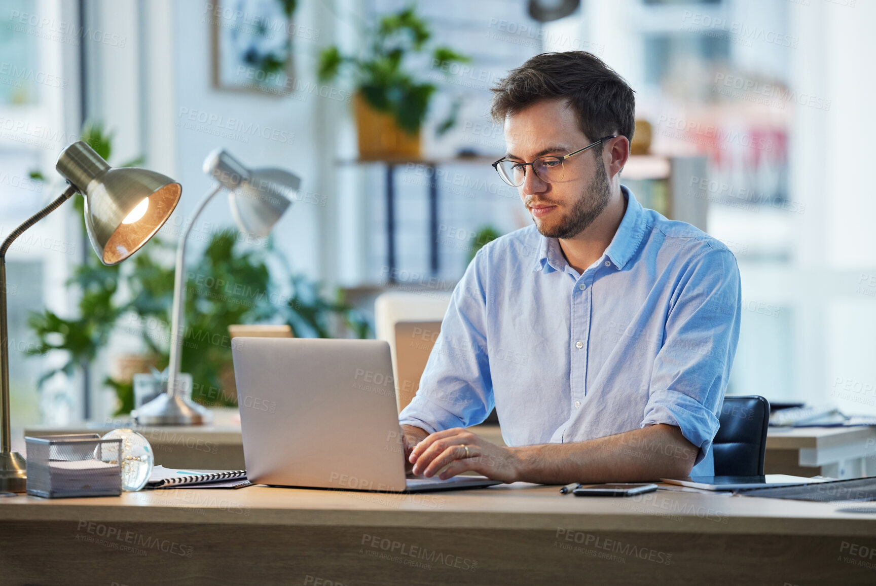 Buy stock photo Laptop, typing and business man, IT and working on web project in office at night. Focus, computer and male professional, programmer and coder writing email, programming website or research deadline.