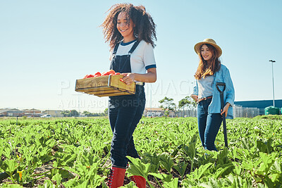 Buy stock photo Shot of two female farmers coming in from a day of harvesting