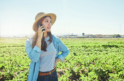 Buy stock photo Shot of a young female farmer using her phone to make a call