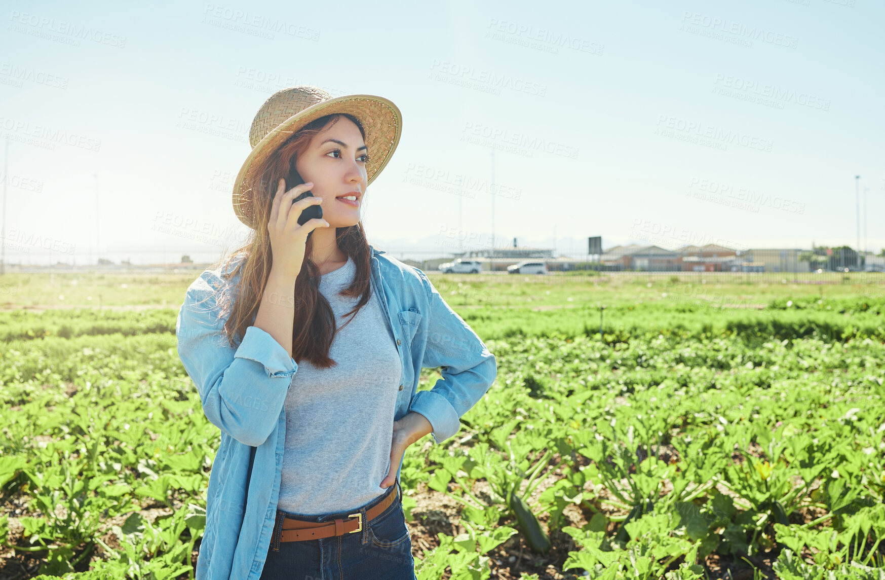 Buy stock photo Shot of a young female farmer using her phone to make a call