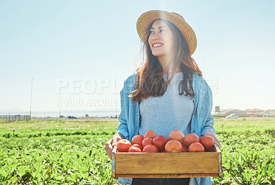 Buy stock photo Shot of a female farmer holding a crate of freshly harvested tomatoes