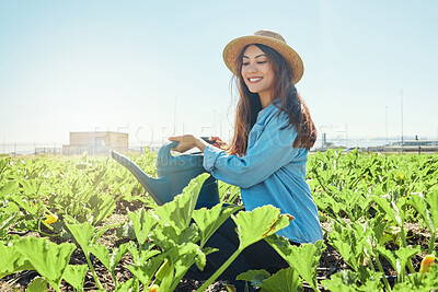 Buy stock photo Shot of a young farmer happily watering her crops