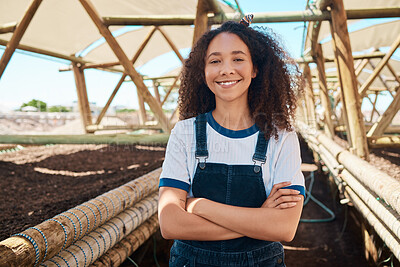 Buy stock photo Portrait of a young woman standing with her arms crossed while working on a farm