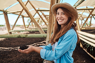 Buy stock photo Portrait of a young woman holding soil in her hands while working on a farm