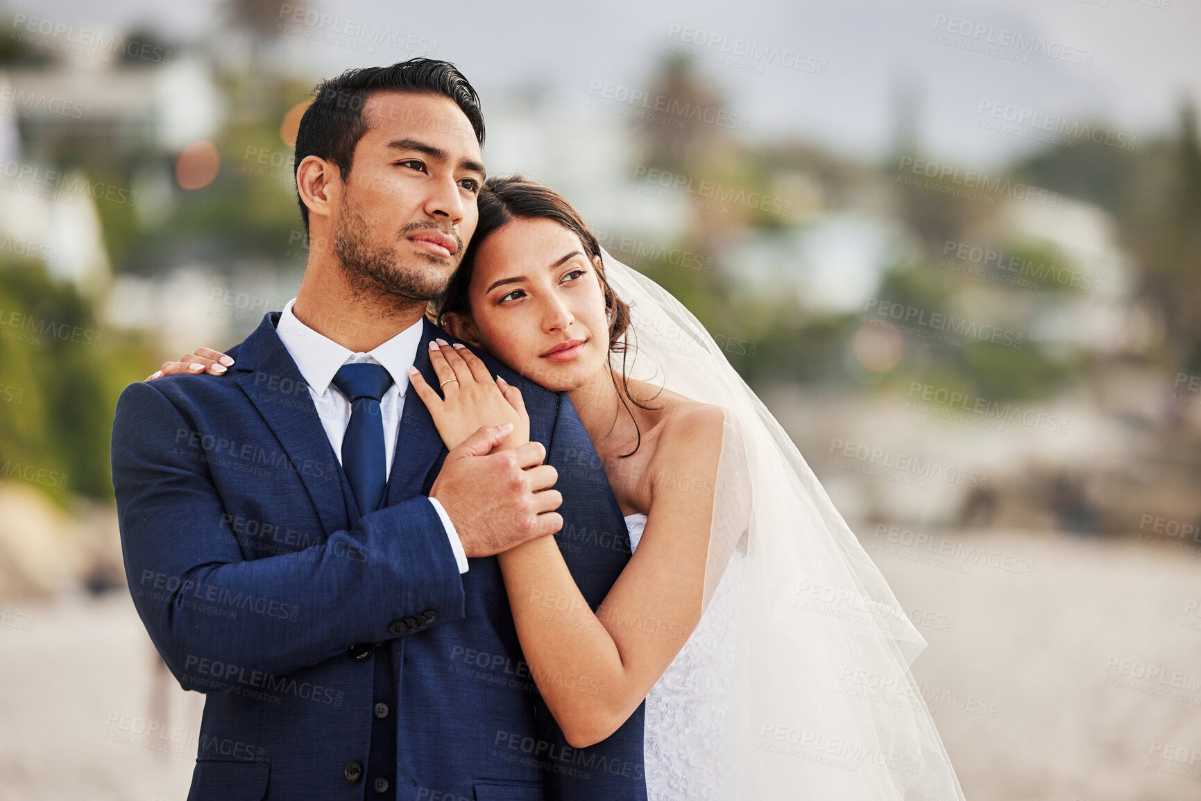 Buy stock photo Shot of a young couple on the beach on their wedding day