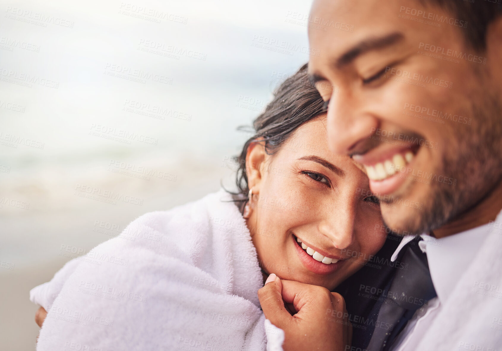 Buy stock photo Shot of a young couple on the beach on their wedding day