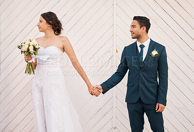 Buy stock photo Shot of a beautiful couple out in the city on their wedding day