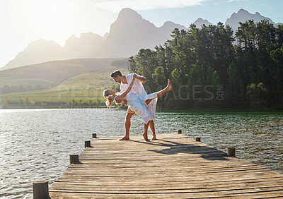 Buy stock photo Love, lake and couple dancing together on the pier while on a romantic vacation, adventure or holiday. Romance, dance and young and and woman on a sidewalk in nature while on a summer weekend trip.