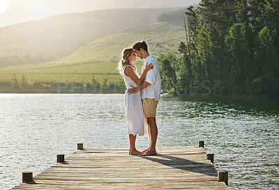 Buy stock photo Couple, lake and engagement announcement of young people in love in nature. Happy, relax and hug of a woman and man together by water outdoor on summer vacation by a lakeside on holiday break