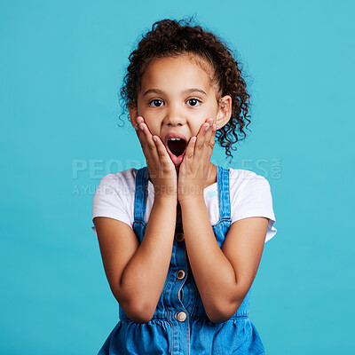 Buy stock photo Portrait, surprise and girl with wow, facial expression and happiness against a blue studio background. Face, female child and young person with shock, wow and gasp with emoji gesture and good news