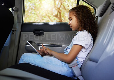 Buy stock photo Child in car, tablet and road trip with seatbelt for safety and device to watch educational video or online game. Technology, internet and summer travel, happy girl on backseat for drive or carpool.