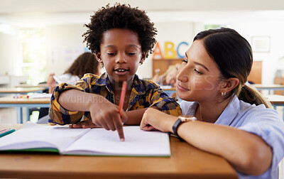 Buy stock photo Teacher, learning and helping black kid in classroom for knowledge, studying or assessment. Question, development and boy or student with woman for education pointing in notebook in kindergarten.