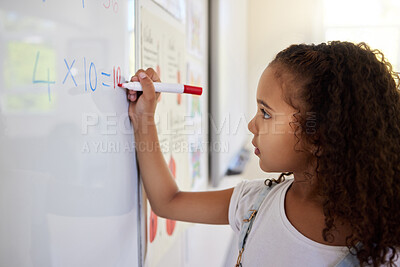 Buy stock photo Whiteboard, math and girl writing for learning, studying and education in classroom. Development, mathematics and kid or student write equations, numbers and multiplication in elementary school.