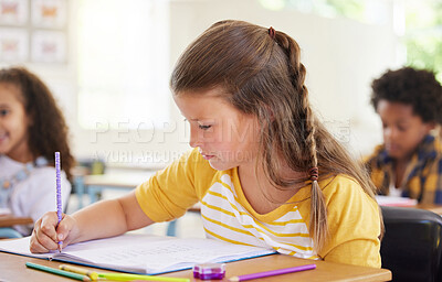 Buy stock photo Education, drawing or girl child in classroom learning, exam or studying with preschool notebooks. Development, smart kids or serious student with creative art writing for knowledge in kindergarten