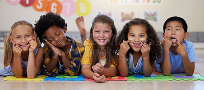 Buy stock photo Kids, floor and group portrait with funny face in school classroom, solidarity or diversity in childhood. Girl, boy and children in class, academy and happy multicultural friends, together or playful