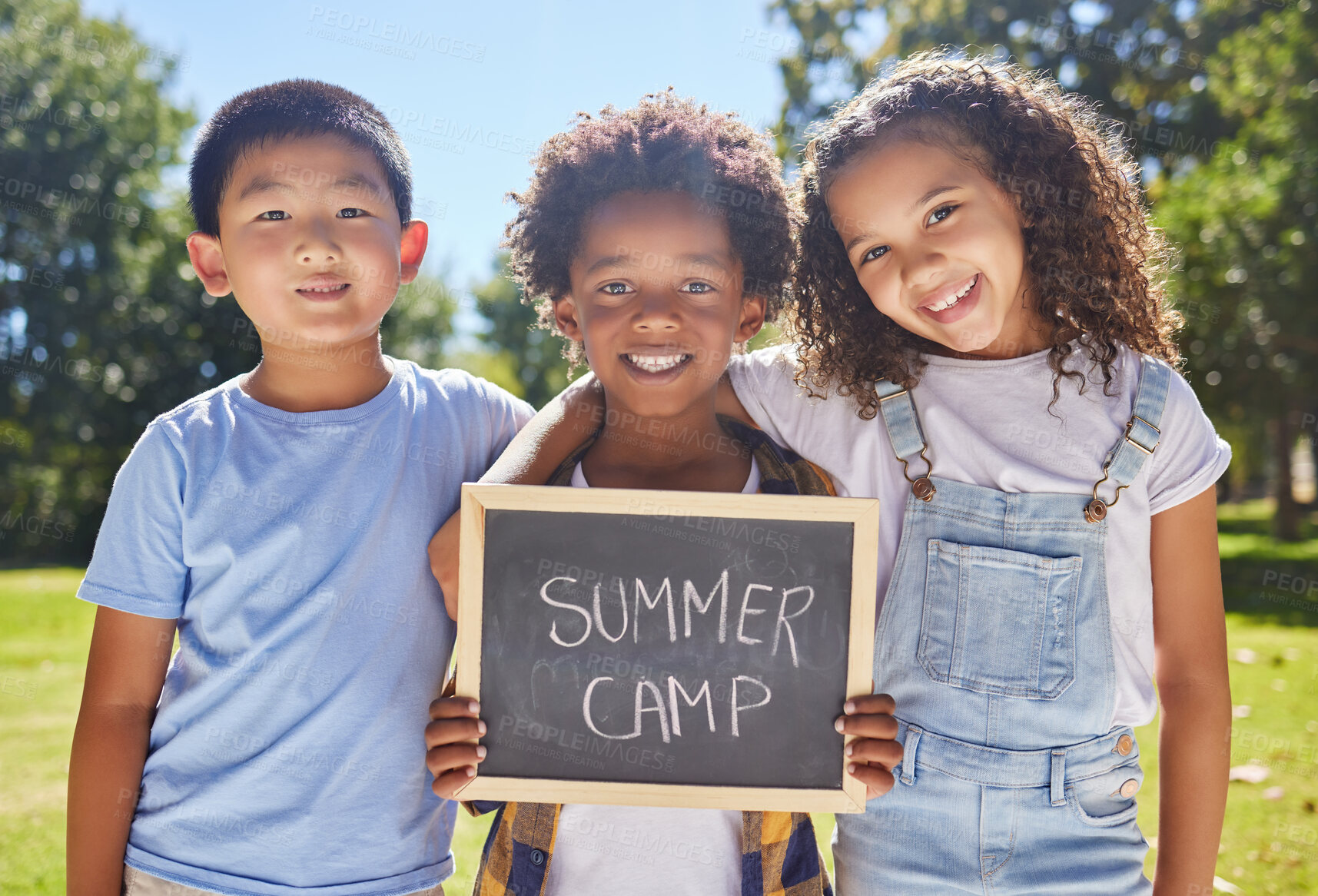 Buy stock photo Summer camp, portrait or children with board in park together for fun, bonding or playing in outdoors. Sign, diversity or happy young best friends smiling or embracing on school holidays outside