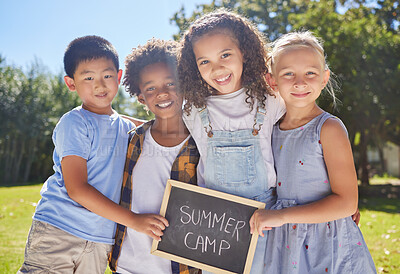 Buy stock photo Summer camp, portrait or kids hugging in park together for fun, bonding or playing in outdoors. Boys, girls or happy young best friends smiling or embracing on school holidays outside with board sign