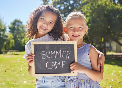 Buy stock photo Summer camp, portrait or girls hugging in park together for fun bonding, development or playing in outdoors. Happy young best friends smiling or embracing on school holidays outside with board sign