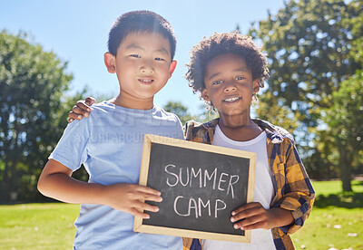 Buy stock photo Summer camp, portrait or boys hugging in park together for fun bonding, development or playing in outdoors. Happy young best friends smiling or embracing on school holidays outside with board sign