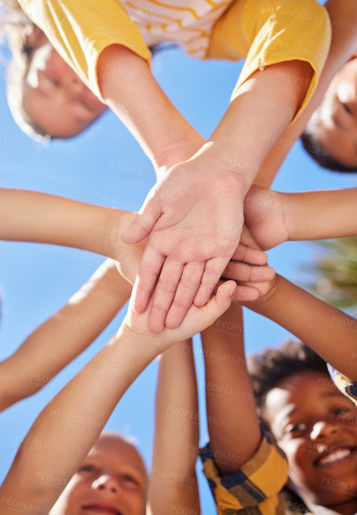 Buy stock photo Below hands stack, children together and outdoor for sunshine, teamwork and learning in summer. Happy kids group, low angle and support with solidarity, diversity and playful in nature for excursion