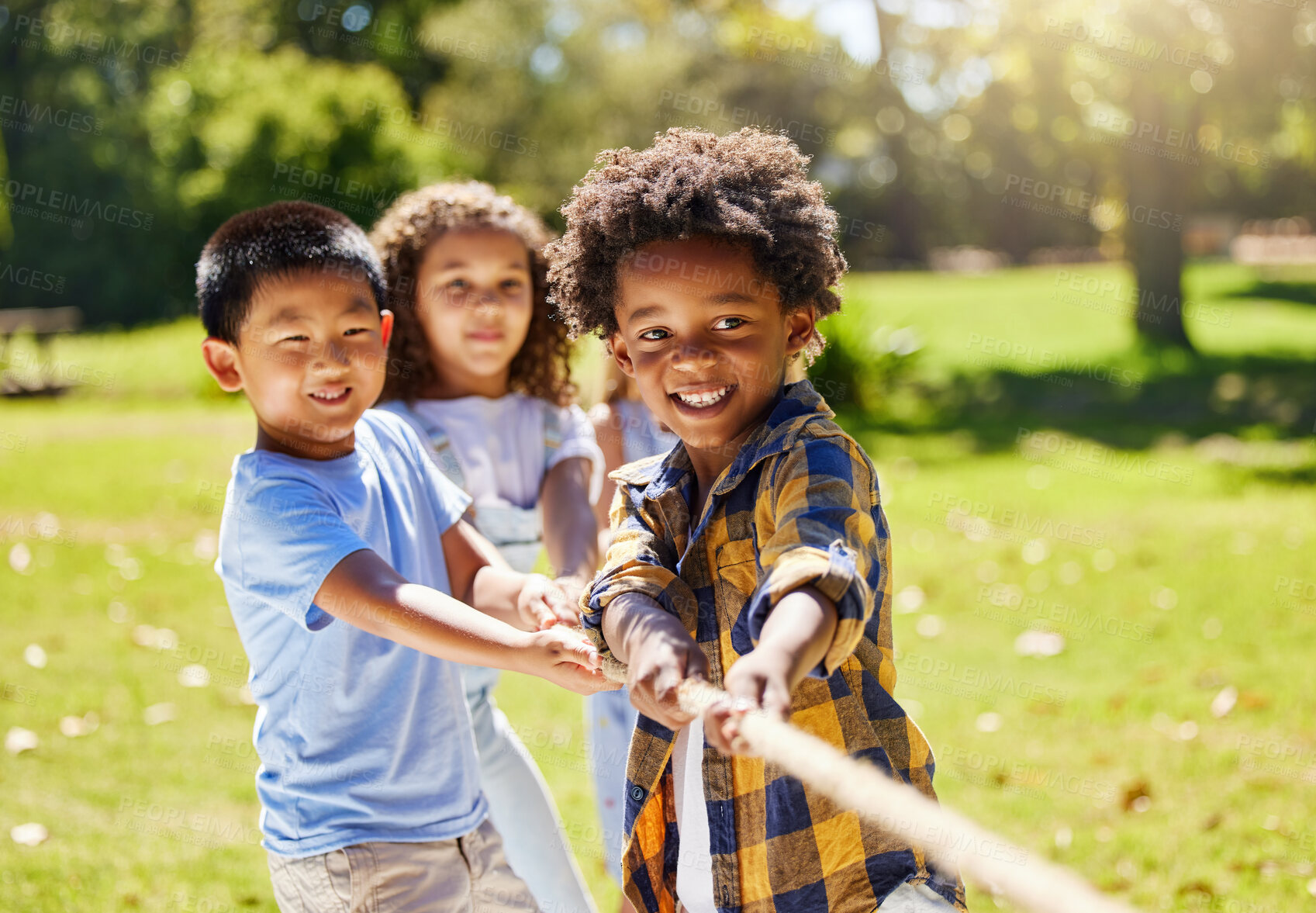 Buy stock photo Fun, games and kids playing tug of war together outdoor in a park or playground in summer. Friends, diversity and children pulling a rope while being playful fun or bonding in a garden on a sunny day