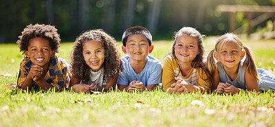 Buy stock photo Portrait, diversity and children on grass, friends and summer break with smile, chilling and relax. Face, kids and young group in park, multiracial and fun on vacation, weekend and joyful together