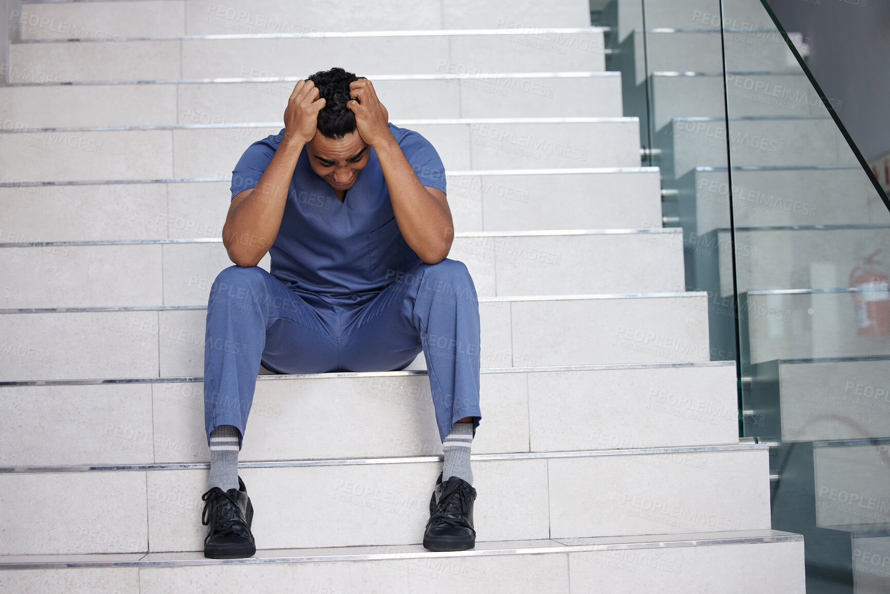 Buy stock photo Sad, doctor and shout with stress at hospital for medical mistake, depression and anxiety from healthcare burnout. Man, relax or scream on stairs with surgery news, mental health and emergency crisis