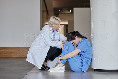 Buy stock photo Shot of a mature female doctor consoling a coworker at work