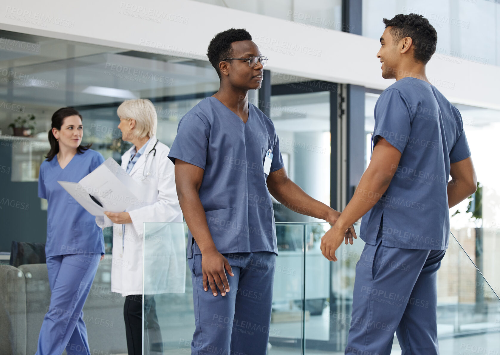 Buy stock photo Shot of a group of doctors working at a modern hospital