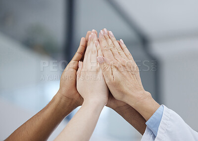 Buy stock photo Shot of a group of unrecognizable people giving each other a high five at work