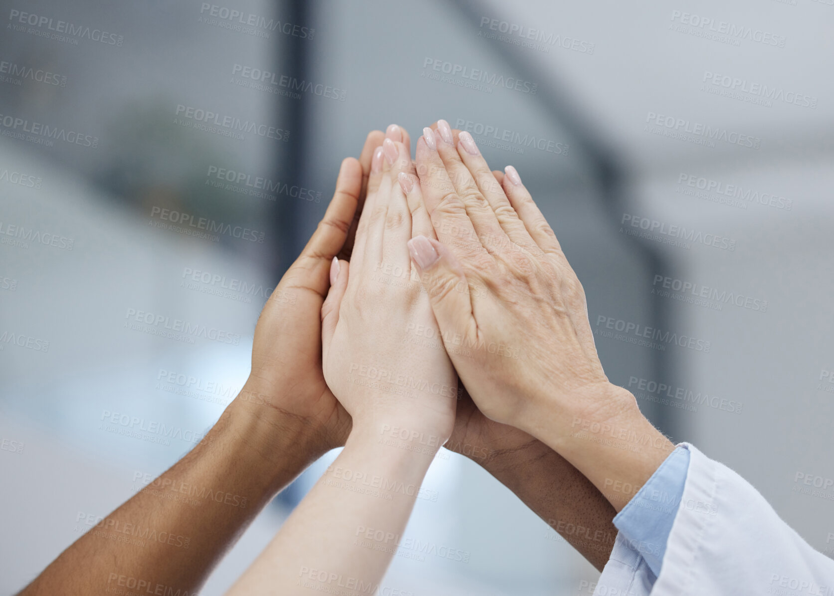 Buy stock photo Shot of a group of unrecognizable people giving each other a high five at work