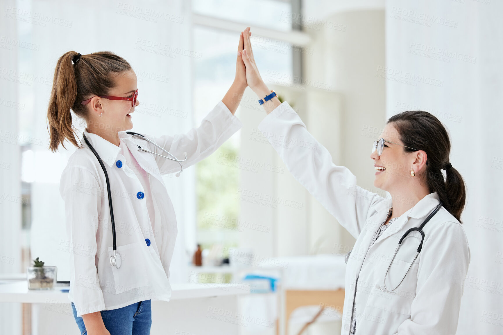 Buy stock photo Doctor, woman and girl with high five in hospital, support and healthcare with advice for career ambition. Medical, professional and kid with hand gesture, motivation and wellness with happiness