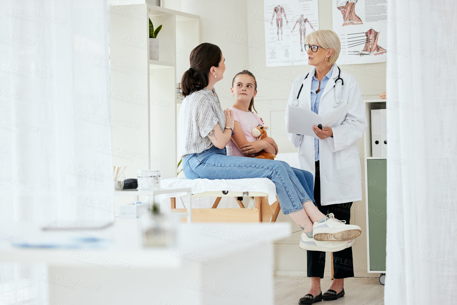 Buy stock photo Shot of a mature female doctor talking to a patient at a hospital