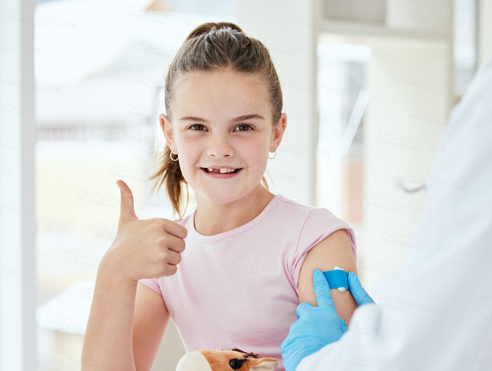 Buy stock photo Thumbs up, girl and happy with band aid as patient at clinic for immunization or vaccine for virus. People, doctor and kid in portrait for injection as prevention for disease and treatment review