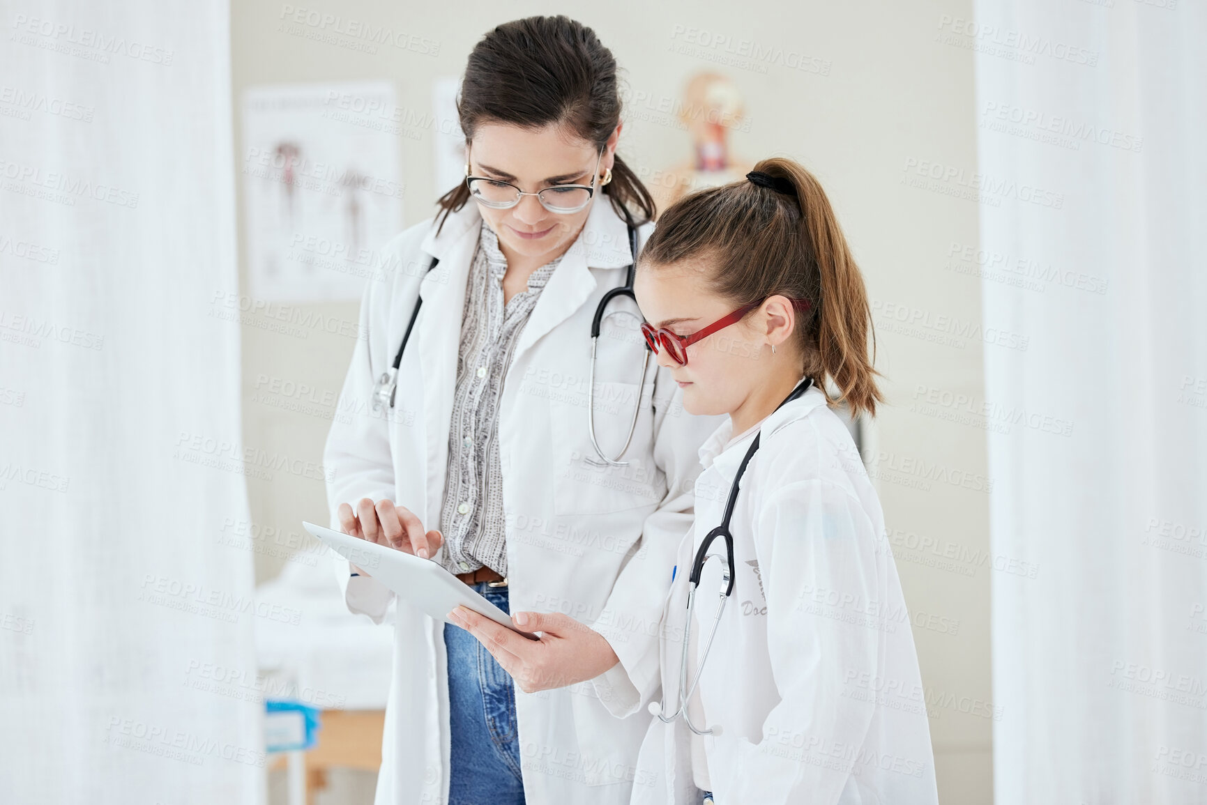 Buy stock photo Tablet, doctor and child at work with learning, dress up and tech at job of mother. Game, future and dream career with playing medical intern with reading data and role model at clinic with teaching