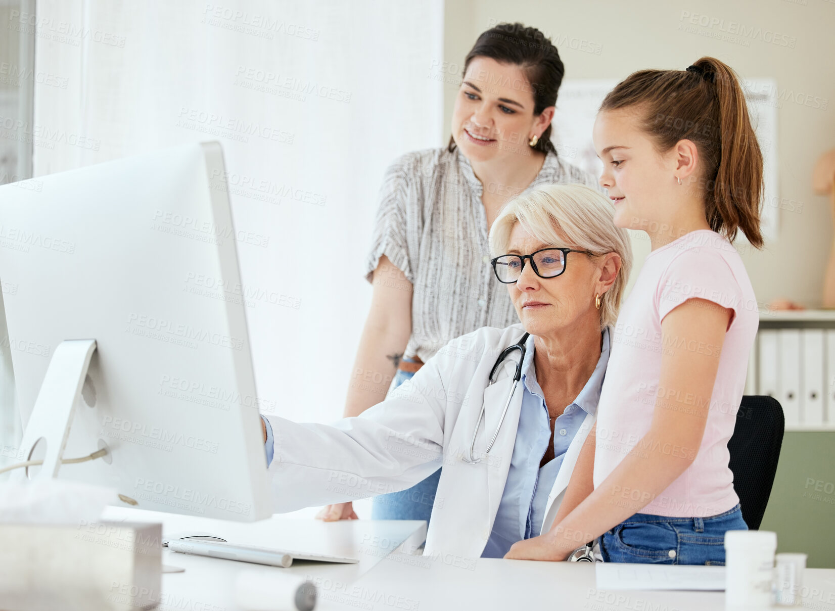 Buy stock photo Women, doctor and mother with girl on computer in office with test report, feedback and results with smile. People, pediatrician and happy parent with kid at clinic for consultation and appointment