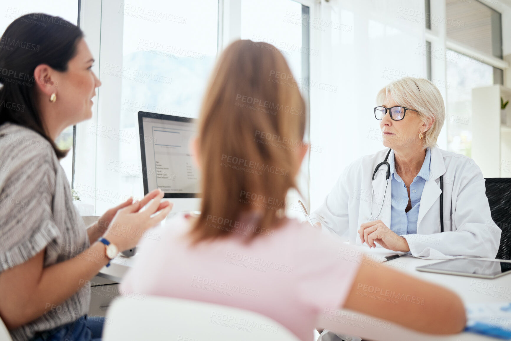 Buy stock photo Checkup, doctor and talking to child, question and mature woman with glasses, diagnosis and worry. Office, mom and daughter in appointment, fear and conversation for health of kid and pediatrician