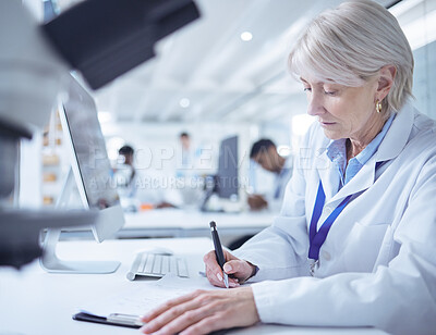 Buy stock photo Shot of a mature scientist recording her findings